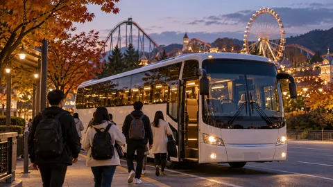 A coach ready for departing theme-park visitors at dusk.