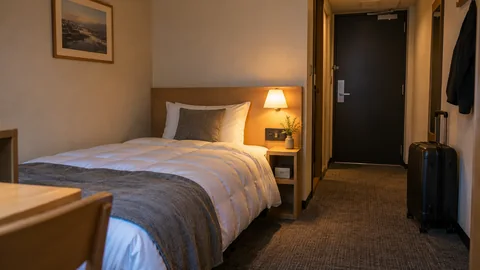 A quiet compact airport-style room prepared for a short rest.