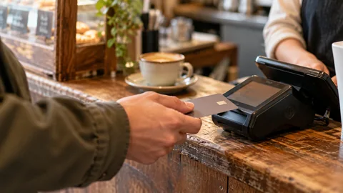 A card terminal and an unbranded payment card at a small Korean cafe counter.