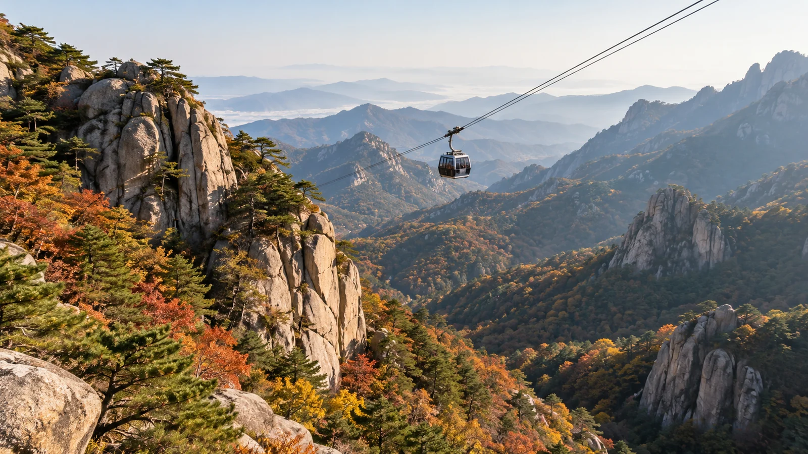 A mountain cable car above a Korean autumn forest.