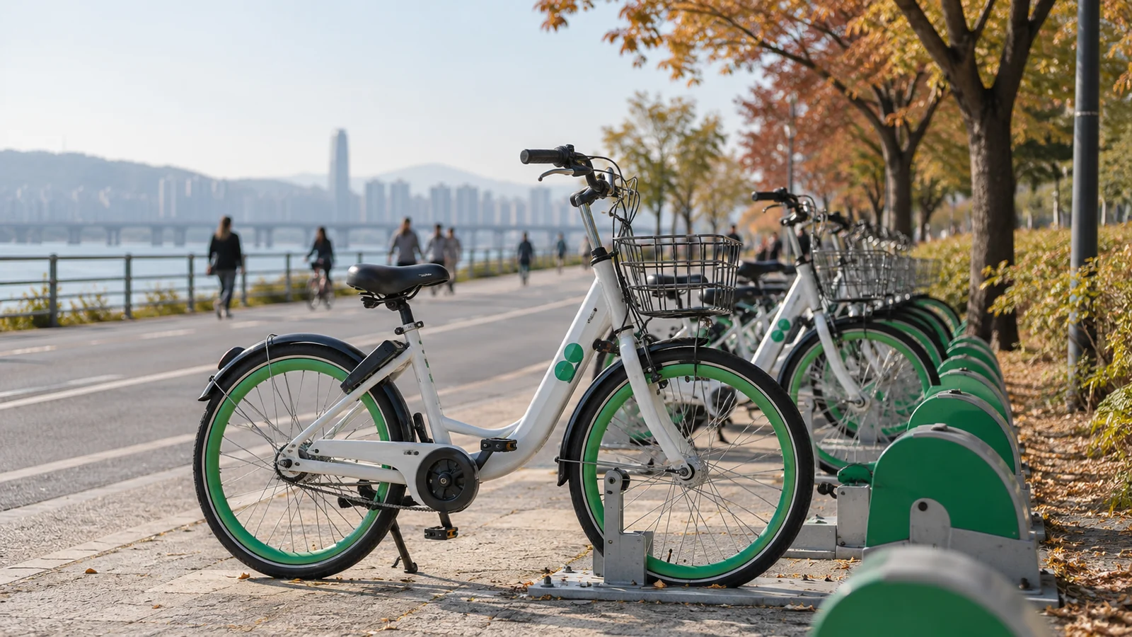 Green and white shared bicycles beside a Seoul riverside path.