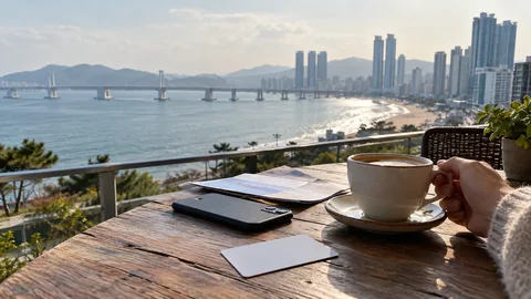 A traveler planning a Busan day beside a coastal city view.
