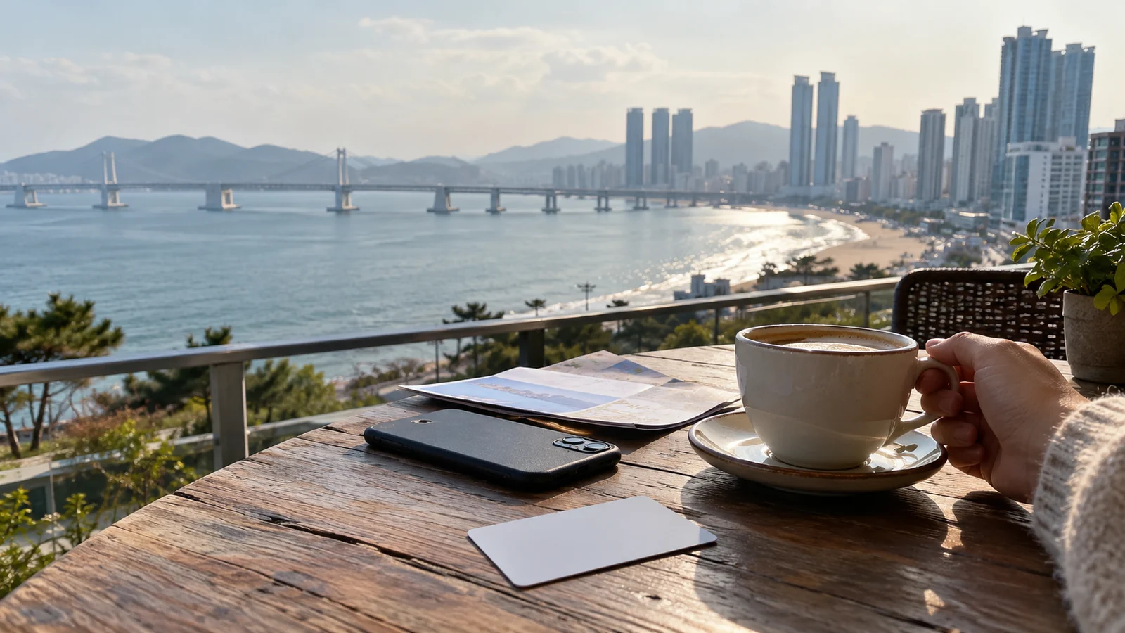 A traveler planning a Busan day beside a coastal city view.